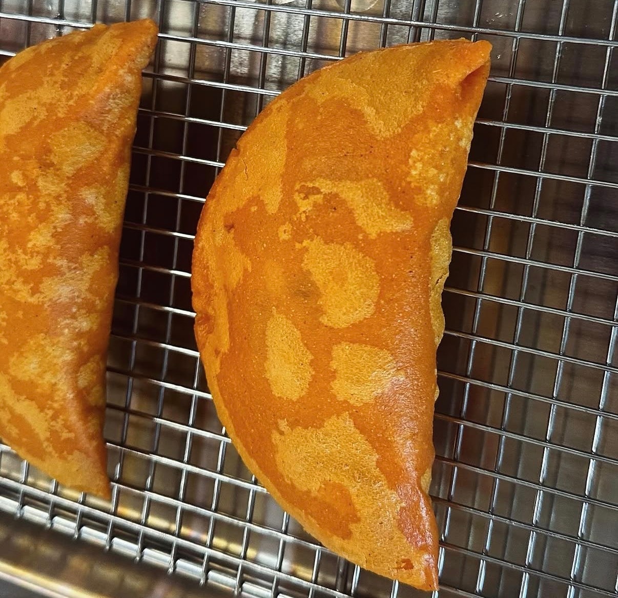 Two golden empanadas fresh from the oven